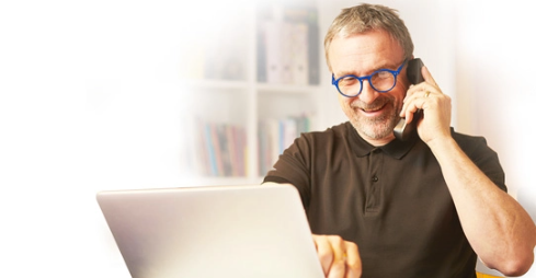 Man Talking on Phone with Laptop