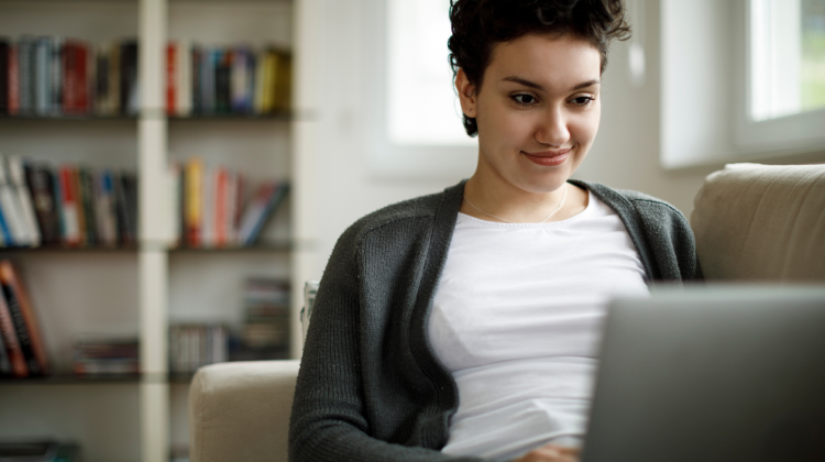 A young lady browsing the laptop, Internet services powered by Brightspeed.