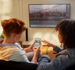 Two women sitting on the couch setting up their Brightspeed Internet account.